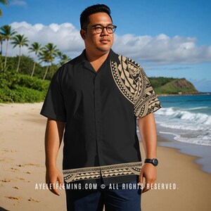 May include: Black button-down shirt with a tan tribal pattern on the right shoulder and bottom hem. The shirt is short-sleeved and has a classic collar. The text "AYELETFLEMING.COM © ALL RIGHTS RESERVED." is printed on the bottom.