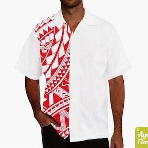 May include: A white short-sleeved button-down shirt with a red and white geometric pattern on the left side. The pattern is reminiscent of Polynesian tribal art.