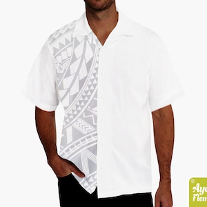 May include: White short-sleeved button-up shirt with a grey and white geometric pattern on the left side of the shirt.