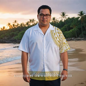 May include: A man wearing a white button-down shirt with a gold and white patterned design. The shirt has a collar and short sleeves. The man is standing on a beach with the ocean in the background. The text "AYELETFLEMING.COM © ALL RIGHTS RESERVED." is at the bottom of the image.