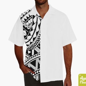 May include: A white short-sleeved button-down shirt with a black and white Polynesian tribal design on the left side of the shirt.