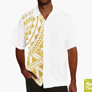 May include: A white short-sleeved button-down shirt with a gold and white geometric pattern on the left side. The pattern is reminiscent of Polynesian tribal art.