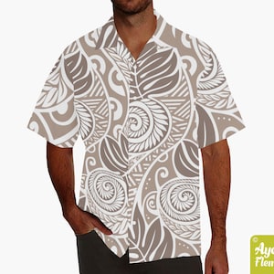 May include: A white short-sleeved button-up shirt with a brown and white patterned design. The pattern features stylized leaves and swirls.