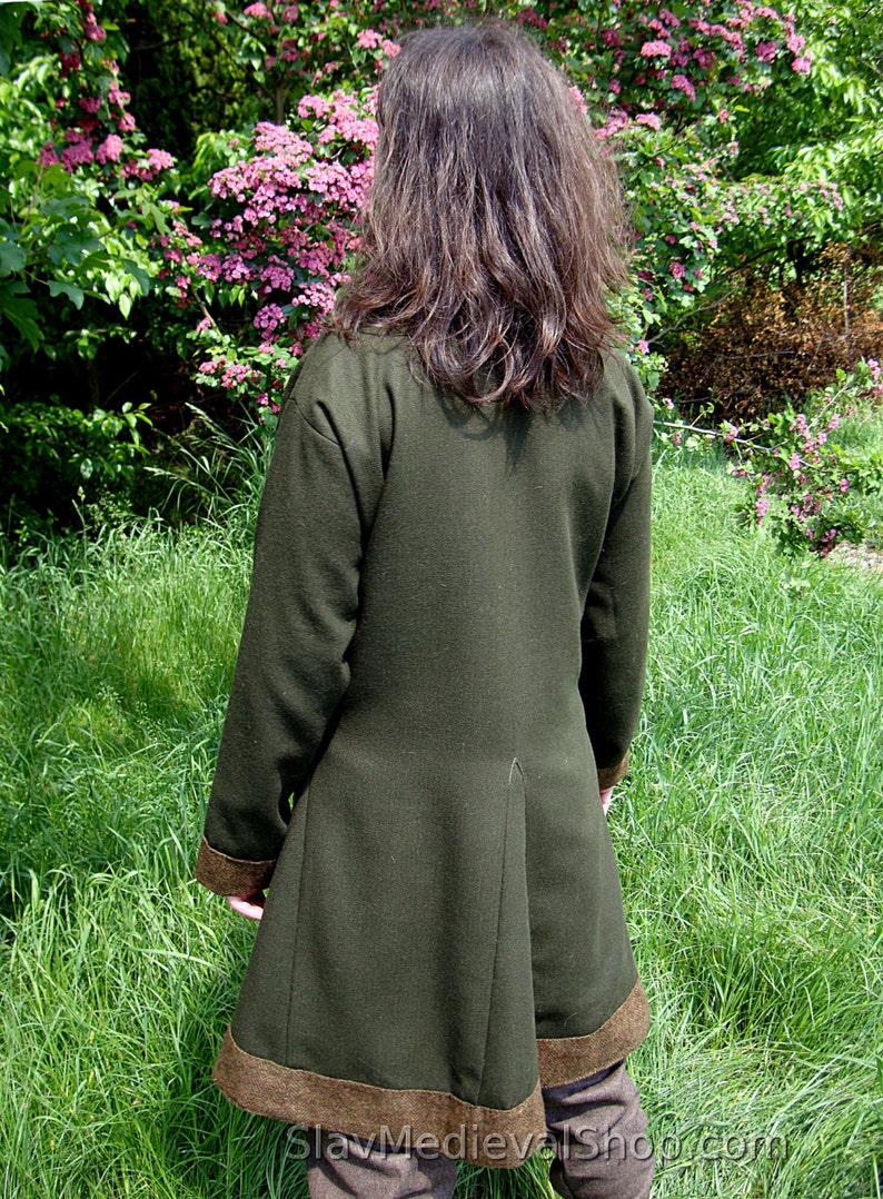 May include: A dark green long-sleeved jacket with a brown trim. The jacket has a long, flowing back and is made of a soft, comfortable fabric.