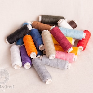 May include: A collection of colorful spools of thread in various shades of red, orange, yellow, green, blue, purple, pink, brown, black, and white.