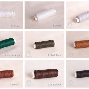 May include: Nine spools of waxed linen thread in various colors, including white, cream, light gray, forest green, dark green, light brown, brown, dark brown, and black. Each spool is labeled with a number and color name.