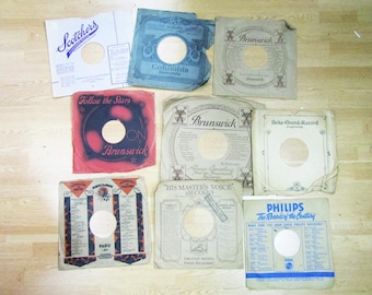 Lote de 20 fundas para discos antiguos de 78 RPM de marcas como Columbia, HMV, Philips, Odeon y Brunswick.