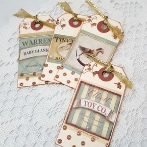 May include: Four vintage-style gift tags with brown, gold, and white polka dots. The tags feature images of a rocking horse, a baby blanket, and a toy store. The text on the tags reads "Warren Baby Blank", "Tiny Tot Shop", and "Elliott Toy Co."