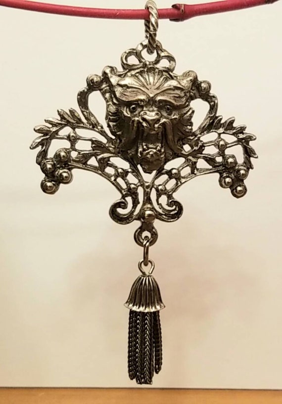 Vintage, silver plated tasseled lion pendant