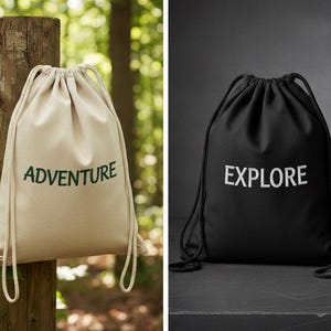 May include: Two drawstring backpacks. One is beige with the word "ADVENTURE" in green. The other is black with the word "EXPLORE" in white. Both bags have a drawstring closure and are made of a soft material.