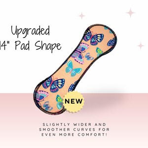 a 14-inch pad shape with a butterfly pattern, and it is described as "Upgraded" and "New" with the tagline "SLIGHTLY WIDER AND SMOOTH CURVES FOR EVEN MORE COMFORT!"