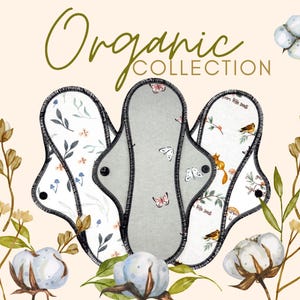 May include: An image of three reusable cloth menstrual pads with floral and butterfly patterns. The pads are in shades of gray and white, with black stitching. The words "Organic Collection" are written in a script font.