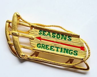 Danecraft "Season's Greetings" sled brooch, pin. Gold tone metal. Christmas winter jewelry accessory. Hostess / host gift. Stocking stuffer