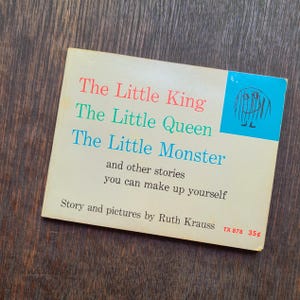 May include: A vintage children's book titled "The Little King, The Little Queen, The Little Monster" with illustrations by Ruth Krauss. The cover features text in red, green, and blue, with a blue illustration of a monster.
