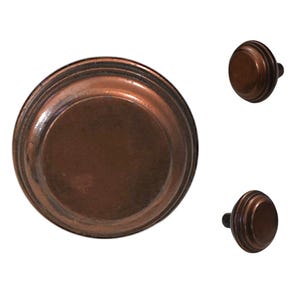 May include: Three antique bronze cabinet knobs. The knobs have a round, ridged design with a dark brown finish. The knobs are likely made of metal and are suitable for furniture restoration or home decor projects.