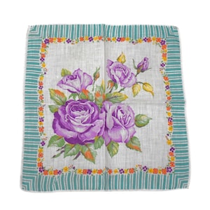 May include: A square white handkerchief featuring a central cluster of purple roses with green leaves. The border consists of a thin frame of small orange and purple flowers, surrounded by a wider teal and white striped edge on all four sides.