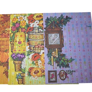 May include: Four rectangular sheets of decorative paper featuring distinct illustrations. The first shows autumn produce and pumpkins. The second displays a yellow watering can and potted flowers. The third depicts sunflowers and a wooden bucket. The fourth shows a wall clock with pine branches and floral patterns.