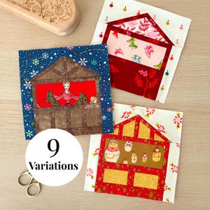 May include: Three square fabric quilt blocks featuring holiday-themed designs. One block shows a person in a window, another displays ice skates on a red background, and the third depicts nesting dolls. Each block has a house-shaped roof structure.