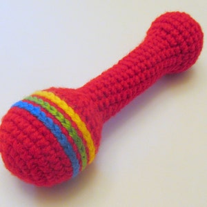 May include: Red crocheted rattle with yellow, green, and blue stripes.