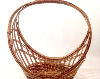 large basket with tall handle; mid century modern; 11 1/2" by 7" and stands 12" tall.