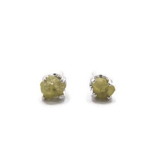 May include: A pair of silver stud earrings with small, rough, green gemstones.