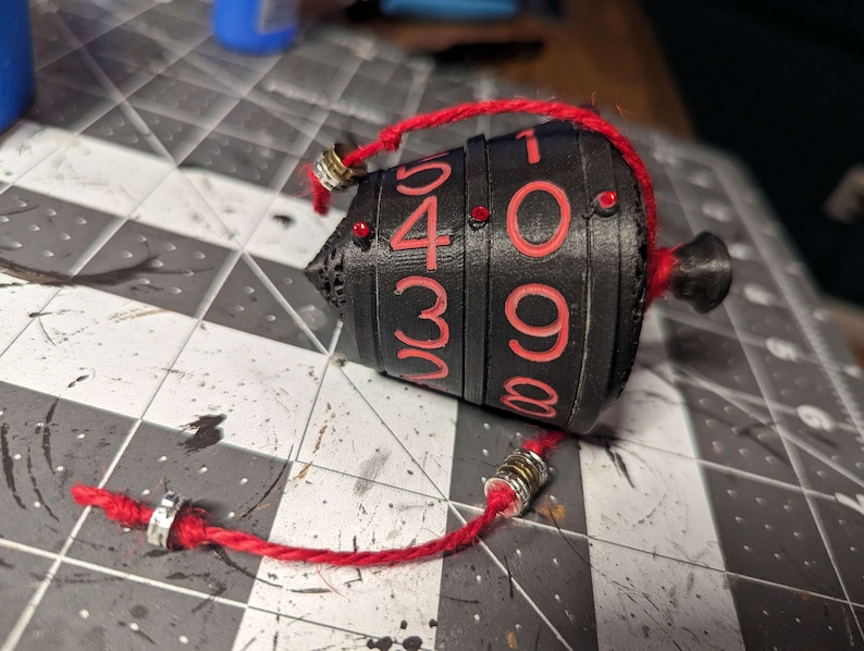 Chromatic collection. 
Dials - Black
Numbers - Red
Top/Bottom/Core - Black
Gem/Cord - Red