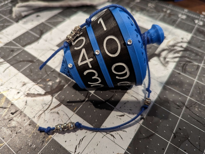 Chromatic collection. 
Dials - Black
Numbers - White
Top/Bottom/Core - Blue
Gem/Cord - Blue