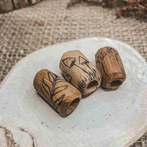 May include: A set of three ceramic mugs with a speckled, matte finish. The mugs are in shades of cream, light gray, and dark gray. Each mug has a simple, minimalist design, perfect for coffee or tea.