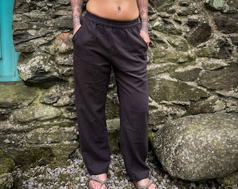 May include: A pair of brown, wide-leg pants with a drawstring waistband. The pants are made of a soft, comfortable fabric and have a relaxed fit.