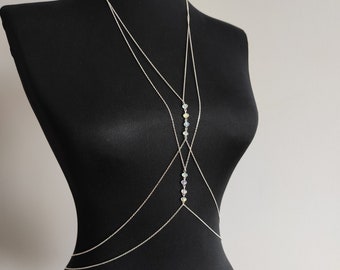 May include: A silver body chain with multiple strands and iridescent crystal accents.
