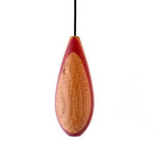 May include: A teardrop-shaped wooden light pull with a dark red wood inlay.