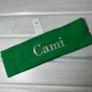 May include: Green headband with the name "Cami" embroidered in white.