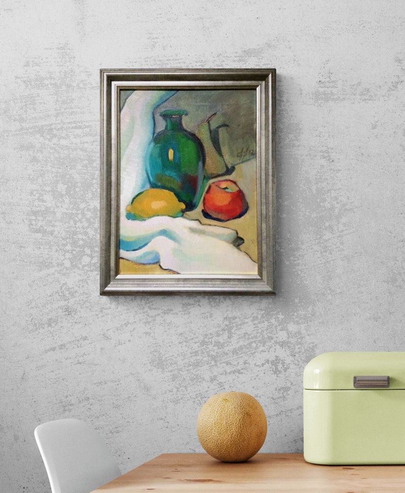 Discover the beauty of our vibrant still life original oil painting, a stunning piece of framed artwork that brings a touch of vintage charm to any space. This one of a kind hand-painted canvas features an exquisite arrangement of fruits and a bottle, captured in an impressionist style that radiates color and warmth. Whether you're looking to enhance your kitchen decor or add a focal point to your dining area, this unique art piece serves as a delightful addition to your home.