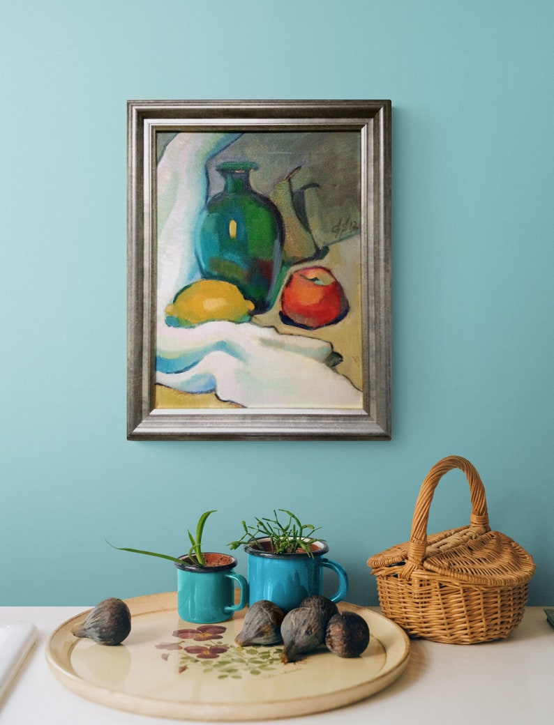 Discover the beauty of our vibrant still life original oil painting, a stunning piece of framed artwork that brings a touch of vintage charm to any space. This one of a kind hand-painted canvas features an exquisite arrangement of fruits and a bottle, captured in an impressionist style that radiates color and warmth. Whether you're looking to enhance your kitchen decor or add a focal point to your dining area, this unique art piece serves as a delightful addition to your home.
