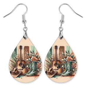 May include: A pair of teardrop-shaped earrings with a rustic country scene. The earrings feature a brown acoustic guitar, a pair of turquoise cowboy boots, a brown cowboy hat, and a floral arrangement with orange roses.