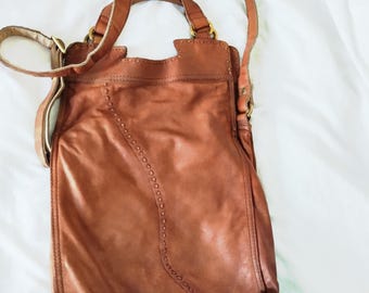 Fold over leather Lucky Brand crossbody or hand bag both. Good condition.