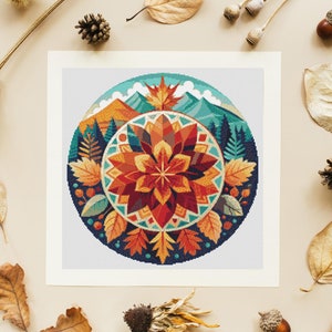 Puede incluir: Un diseño circular de mandala con una flor roja, naranja y amarilla en el centro. El fondo es un paisaje azul y verde con montañas y árboles. El mandala está rodeado por un anillo de hojas en varios tonos de marrón, naranja y amarillo.