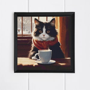 May include: A black and white cat wearing a red scarf sits at a table with a cup of coffee. The cat is looking at the camera.