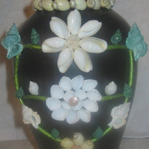 Hand-decorated shell vase, brimming with elegant style--with flowers included.