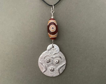 Silver mask pendant with etched agate protection bead