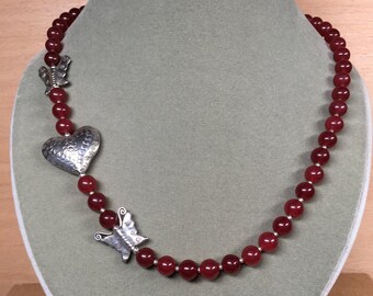 Heart and butterflies in Hill Tribe silver on necklace of cherry quartz