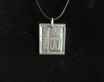 Petroglyph pendant of antiqued fine silver