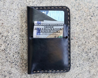 black Horween steer hide credit card wallet. made by hand in Ithaca, NY. sewn with a saddle stitch.