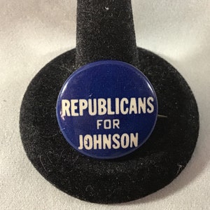 May include: A blue button with white text that reads "Republicans for Johnson".