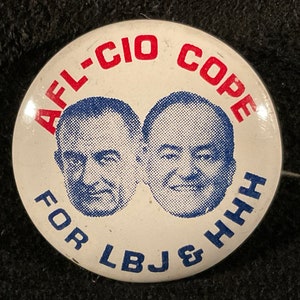 May include: A white button with red and blue text that reads "AFL-CIO COPE FOR LBJ & HHH". Two men's faces are pictured in the center of the button.