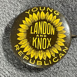 May include: A round political pinback button featuring a yellow sunflower graphic on a dark background. The text reads YOUNG LANDON AND KNOX REPUBLICAN in yellow capital letters arranged around the sunflower and across the center of the button.