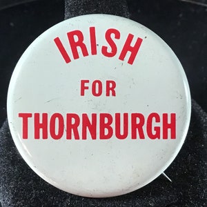 May include: White button with red text that reads "Irish for Thornburgh".
