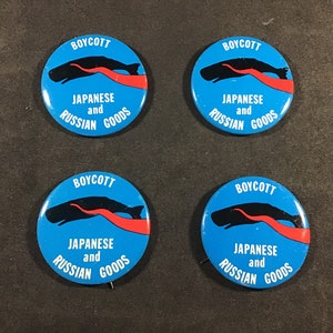 May include: Four blue and white button badges with the text "BOYCOTT JAPANESE and RUSSIAN GOODS" and a black whale with a red tentacle.