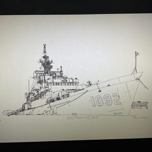 May include: A detailed black and white line drawing of the USS Thomas C. Hart, a naval vessel. The ship is depicted at an angle, showcasing its structure, with the number "1092" prominently displayed on its side. The name of the ship is written below.