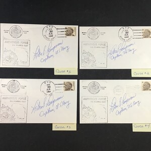 May include: Four white envelopes with a black and white image of a ship and the text "AMPHIBIOUS FORCE U.S. ATLANTIC FLEET". Each envelope has a stamp with the text "U.S.S. BOXER 1943" and a signature that reads "Arthur L. Thompson Captain, U.S. Navy". The envelopes are labeled "Cover #1", "Cover #2", "Cover #3", and "Cover #4".